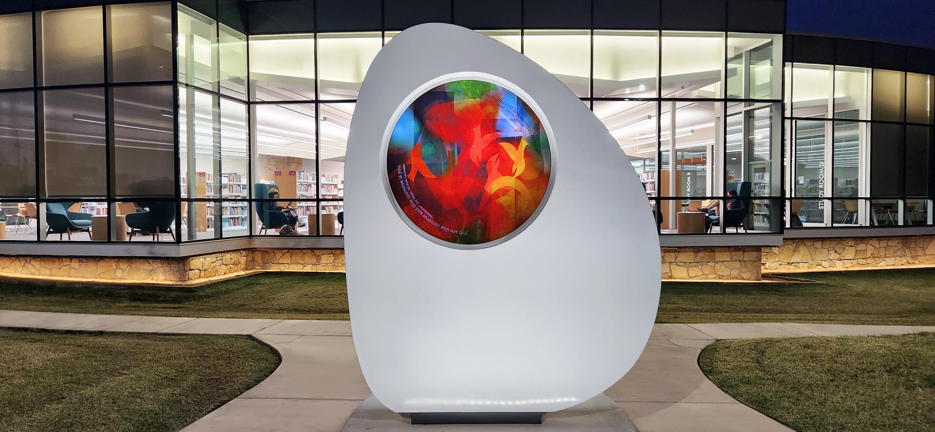 Nourish Sculpture at night in front of Belle Isle Library