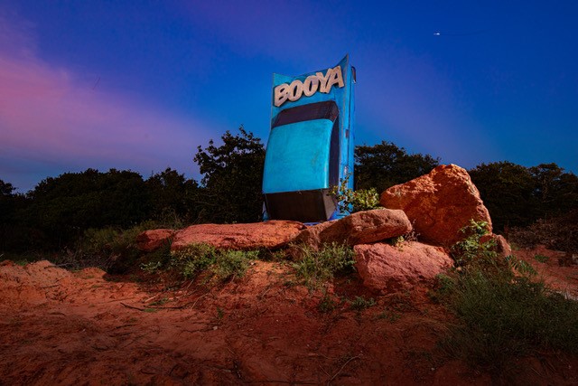 Car sculpture in the ground called Booya at Lake Stanley Draper