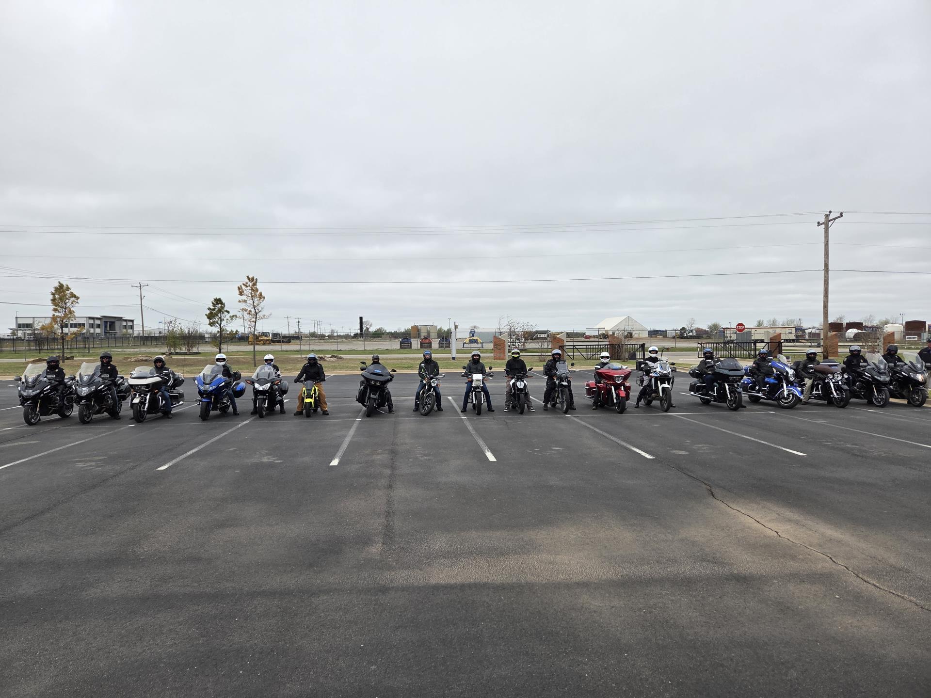 line of motorcyclists in a parking lot