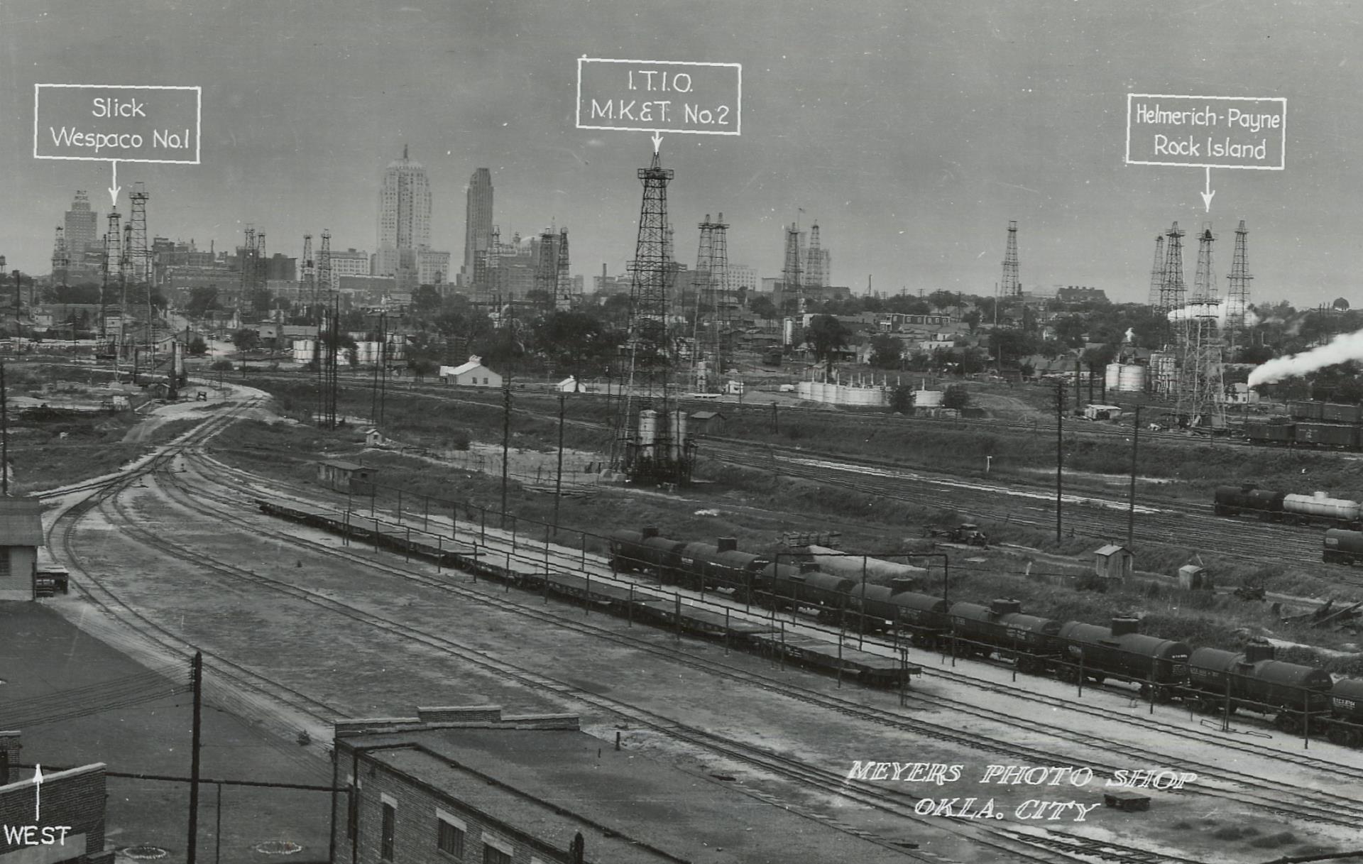 Oklahoma City downtown with oil derricks 