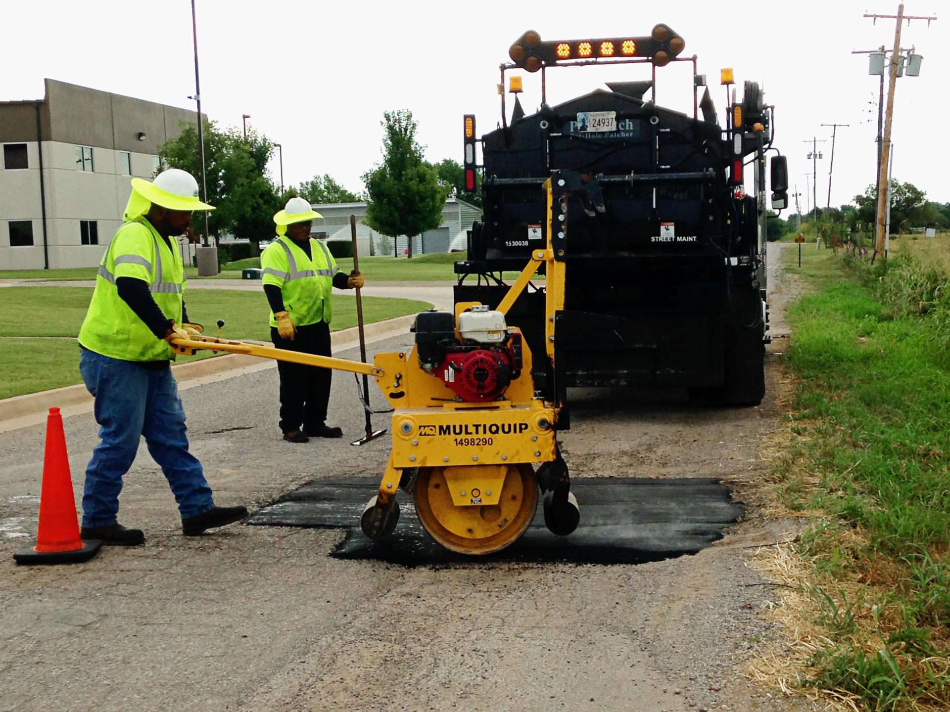 A team repairing a pothole