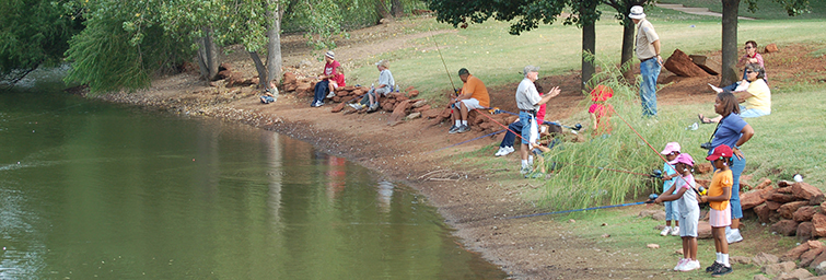 Campers fish along the shoreline of Spring Lake
