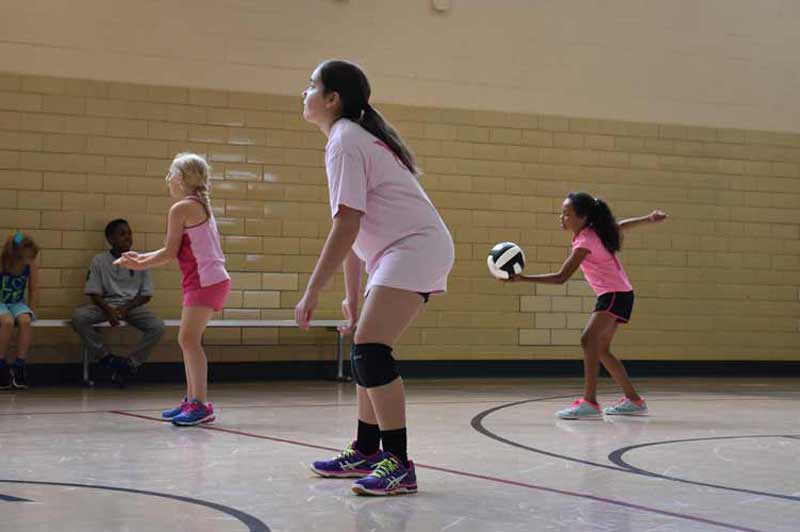 Boys and girls participate in our summer volleyball camp